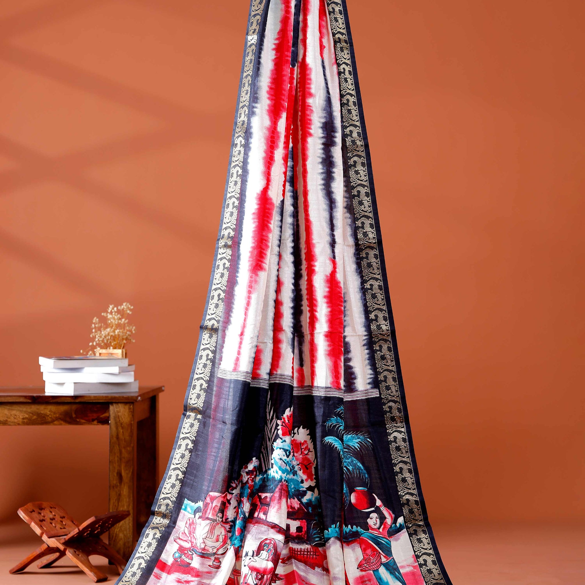 Elegant Red shades and the rural scenic artwork Dola Saree