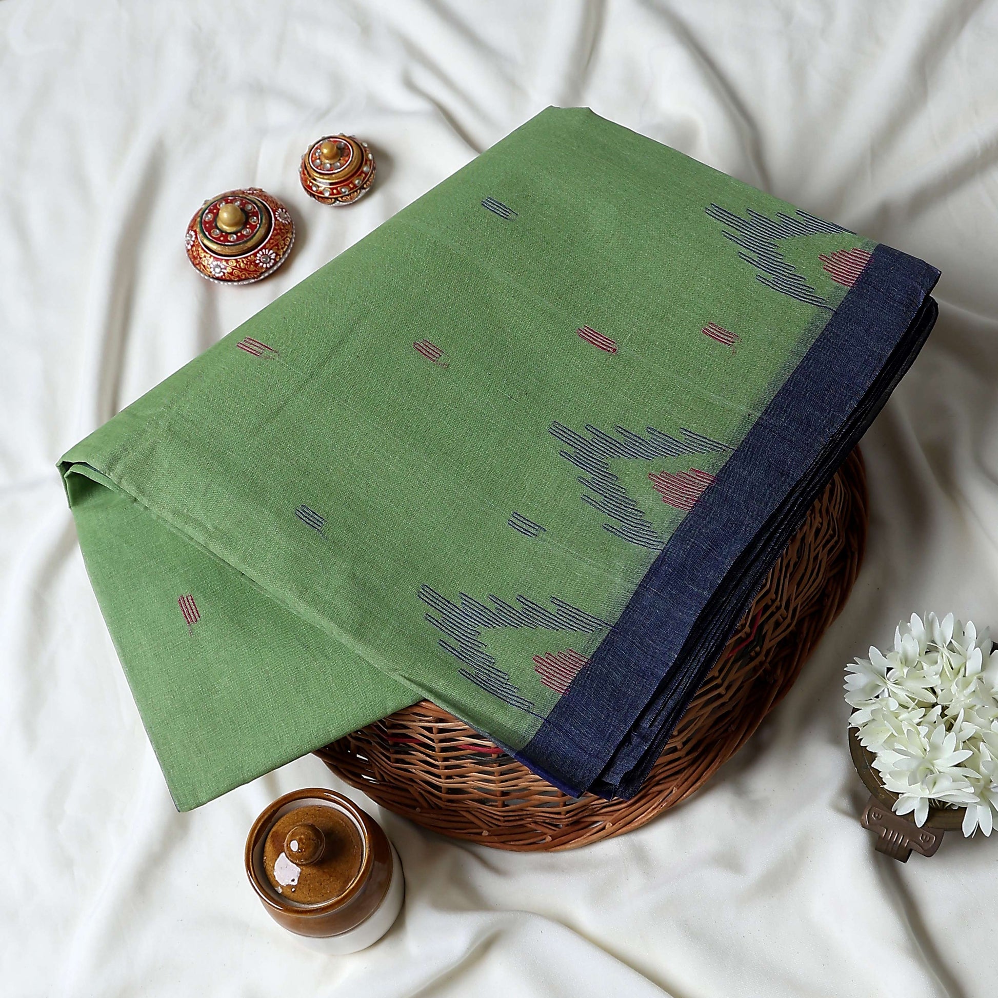 Bengal Cotton Saree With White Woven Butti Motifs And Plain Blue Border In Green Folded Flat View