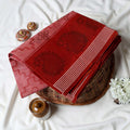 Red Bengal Cotton Saree Featuring Floral Butta Motifs And Striped Border Folded Product Close Up View