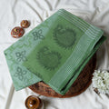 Green Bengal Cotton Saree Featuring Floral Butta Motifs And Striped Border Folded Product Close Up View
