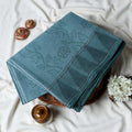 Blue Bengal Cotton Saree Featuring Subtle Woven Motifs And Temple Border Folded Close Up View