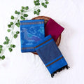 Top View Of Blue And Dark Pink Salwar Suit Material With Striped Dupatta Ikkat Woven Borders,Tassel Details And Matching Fabric Piece