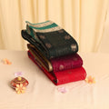 Elampillai silk cotton saree stack with zari buttas and vertical stripes in assorted colors folded display view
