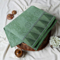 Green Bengal Cotton Saree Subtle Woven Motifs And Striped Border Folded Close Up View