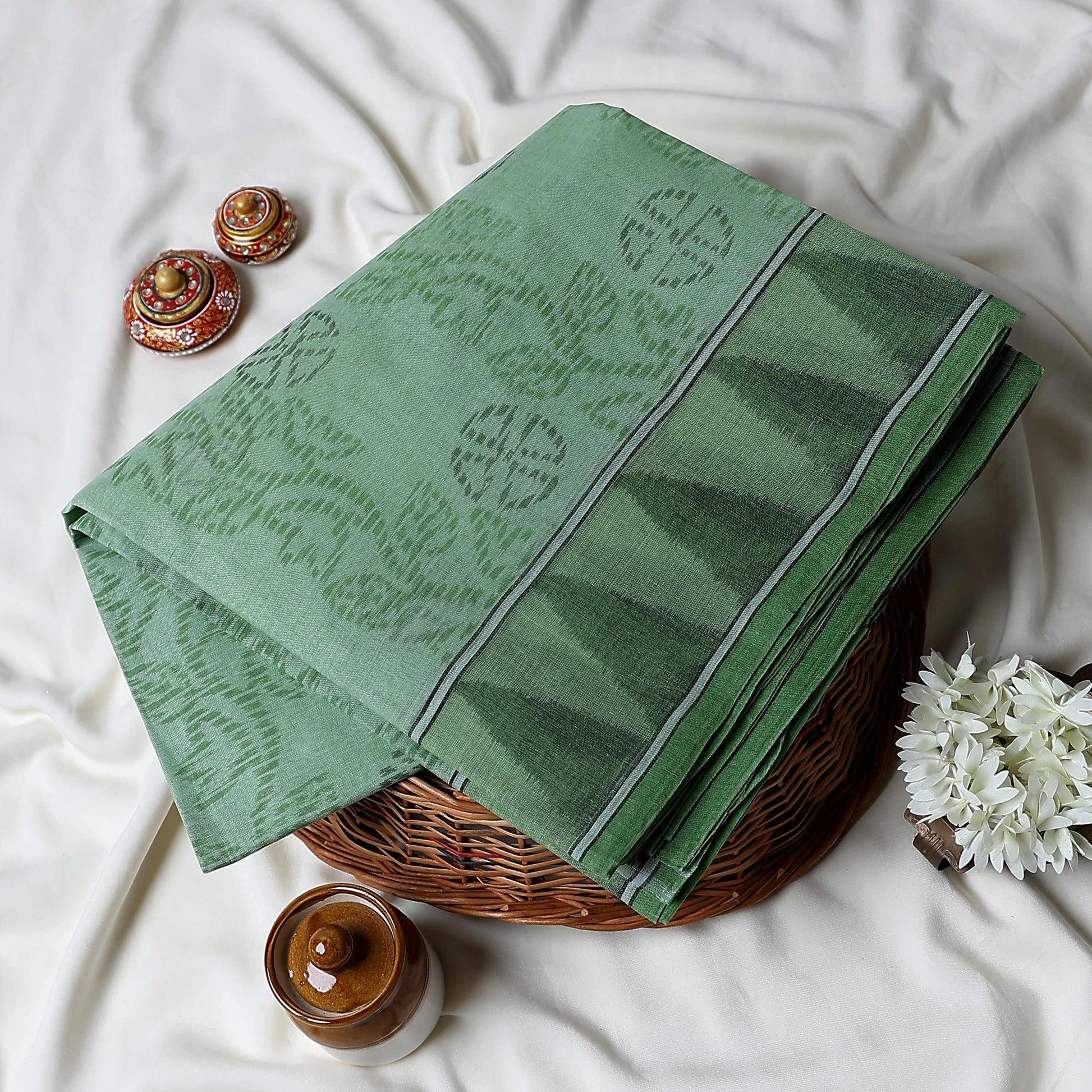 Green Bengal Cotton Saree Subtle Woven Motifs And Striped Border Folded Close Up View