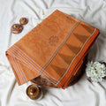 Orange Bengal Cotton Saree Featuring Subtle Woven Motifs And Temple Border Folded Close Up View