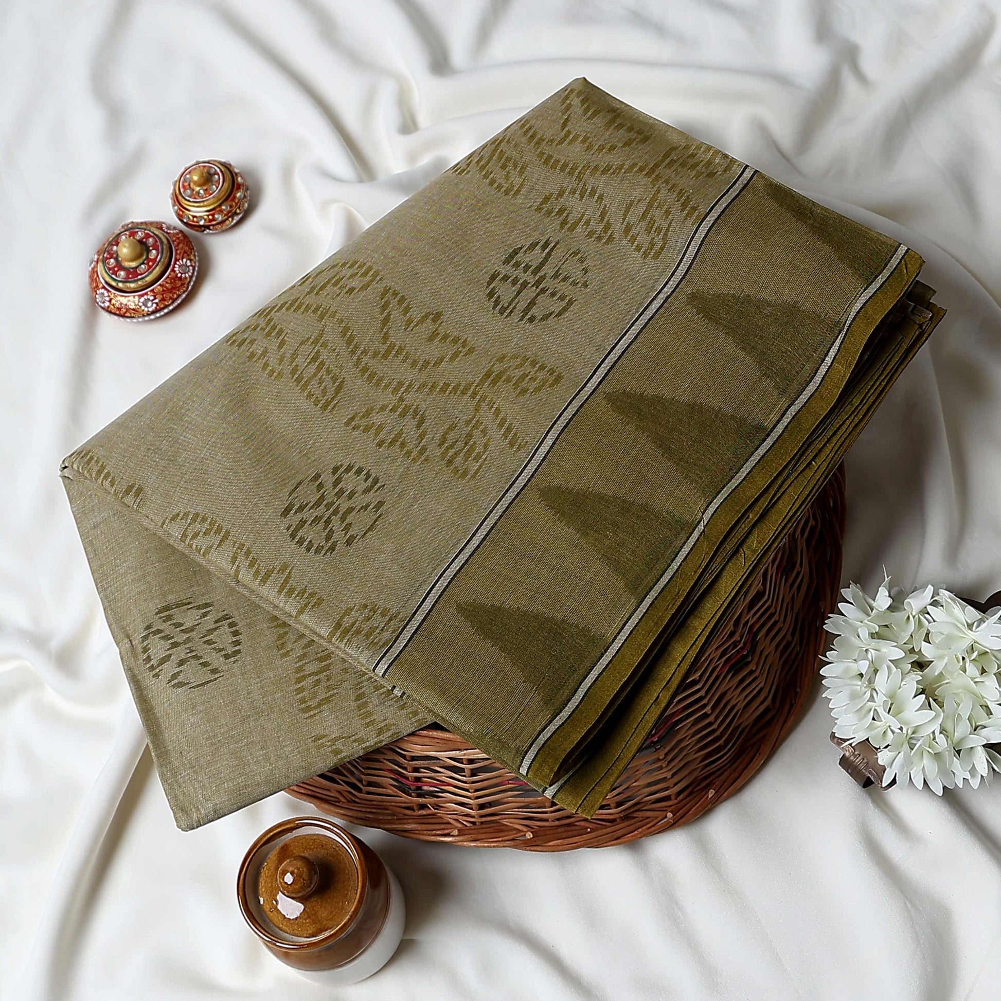 Olive Green Bengal Cotton Saree Featuring Subtle Woven Motifs And Striped Border Folded Close Up View