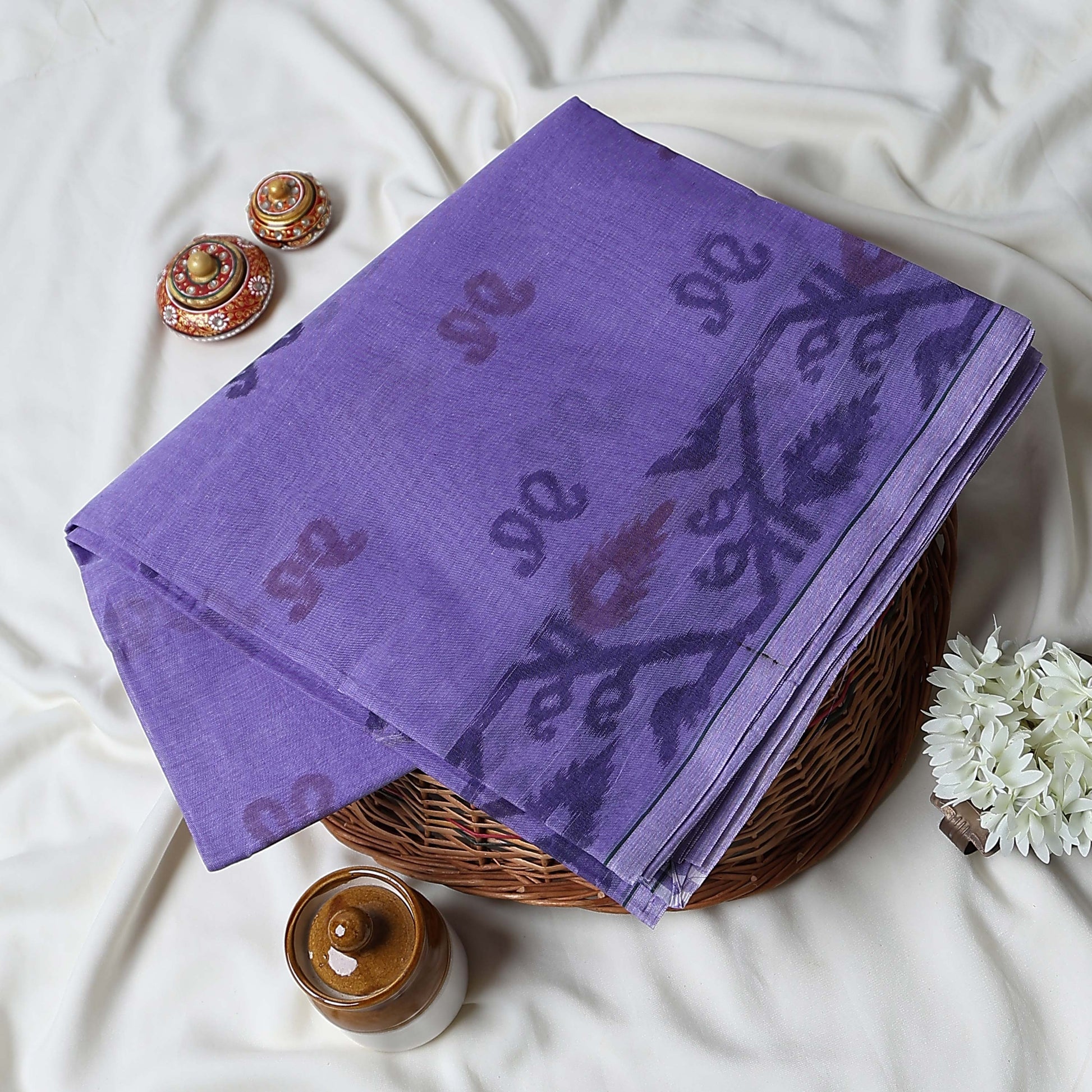 Bengal Cotton Saree With Subtle Floral And Abstract Woven Motifs In Purple Folded Close Up Display View