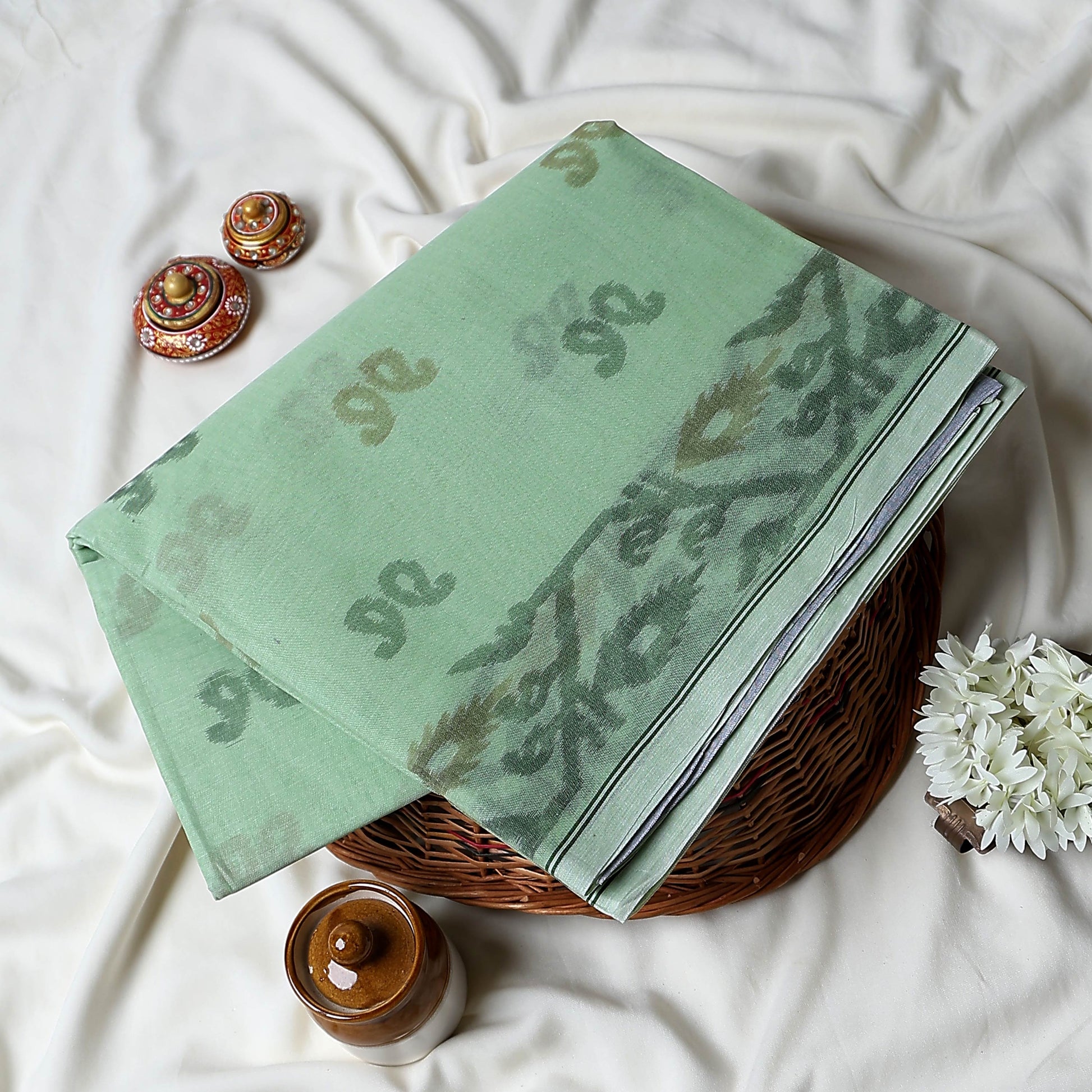 Bengal Cotton Saree With Subtle Floral And Abstract Woven Motifs In Green Folded Close Up Display View