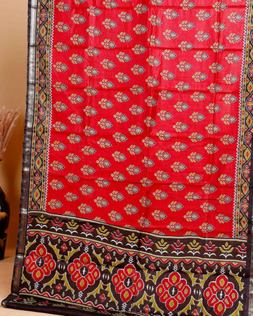 Rich Maroon Patola Silk Saree with Intricate Floral Motifs and Black Contrast Pallu