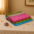 Voile cotton sarees with woven butta motifs and contrast zari borders in assorted colors folded stack front view