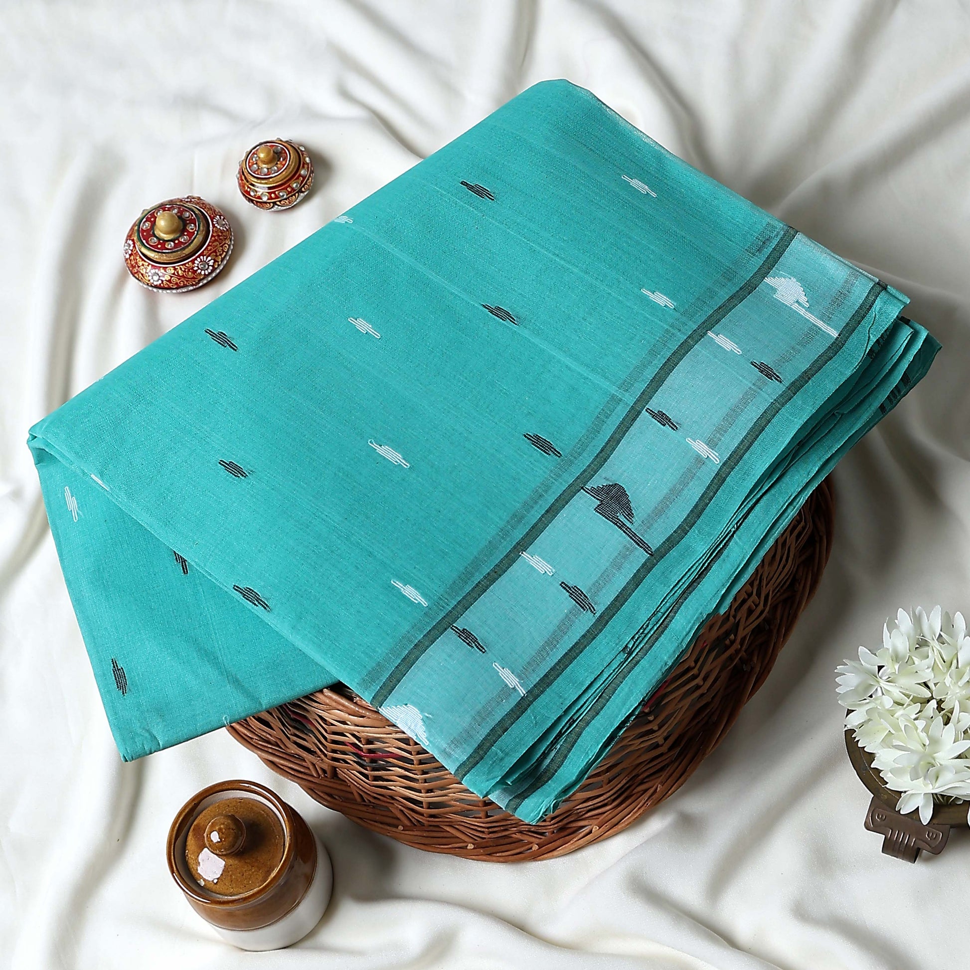 Bengal Cotton Saree With Subtle Woven Motifs And Decorative Border In Aqua Blue Folded Display Close Up View