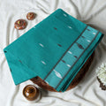 Bengal Cotton Saree With Subtle Woven Motifs And Decorative Border In Aqua Green Folded Display Close Up View