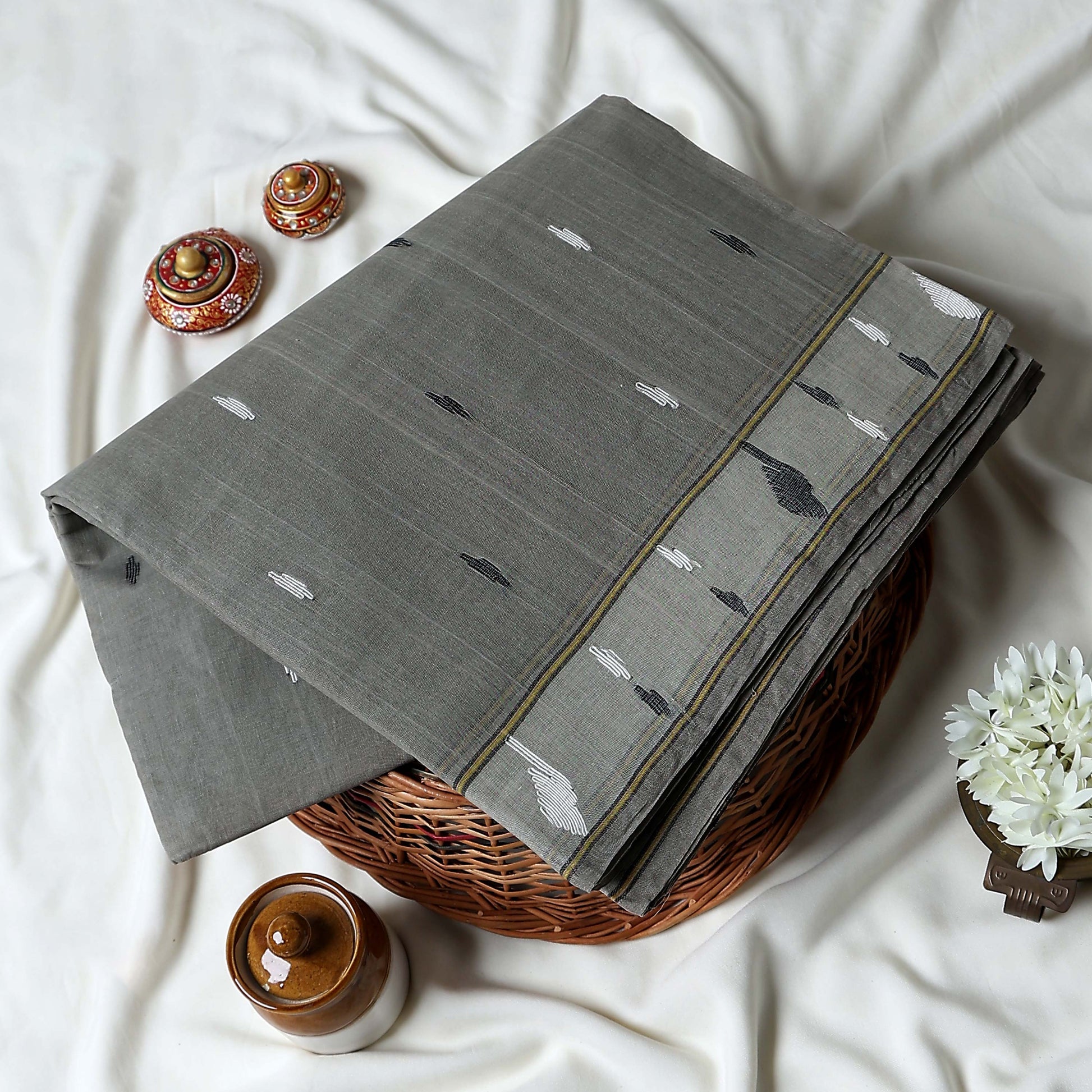 Bengal Cotton Saree With Subtle Woven Motifs And Decorative Border In Grey Folded Display Close Up View