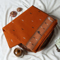 Bengal Cotton Saree With Subtle Woven Motifs And Decorative Border In Orange Folded Display Close Up View