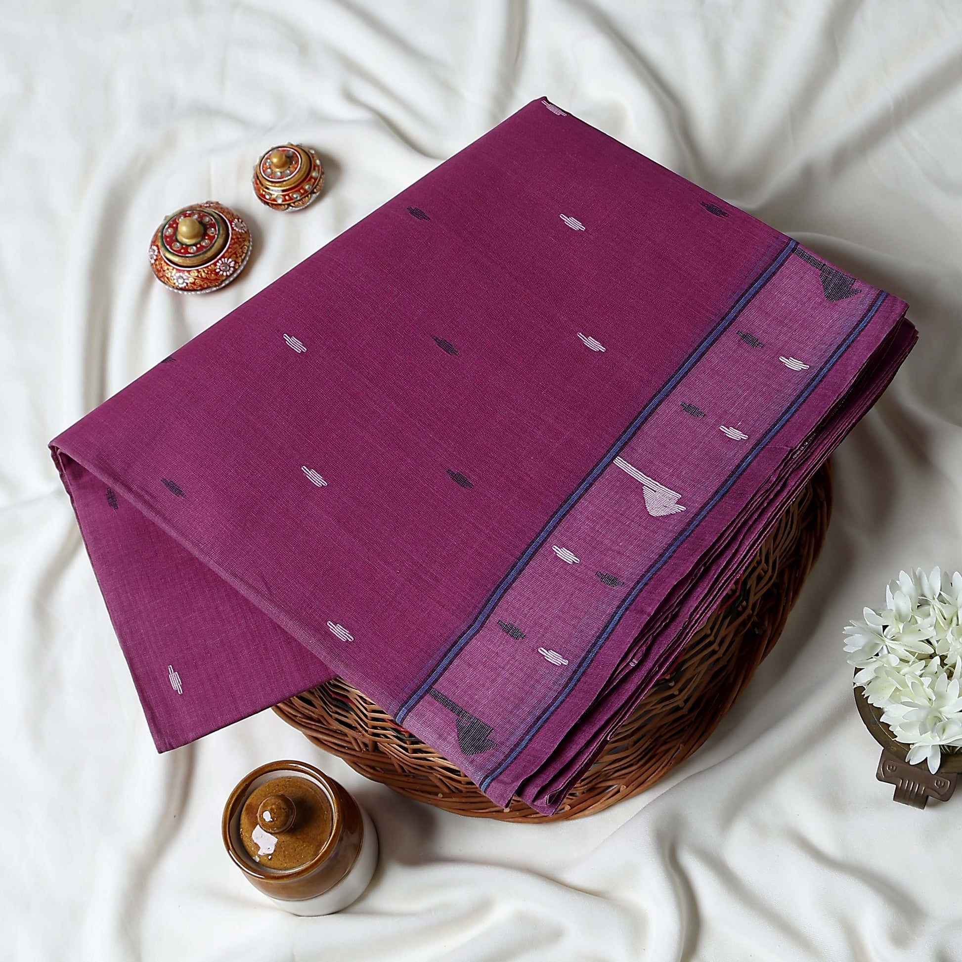 Bengal Cotton Saree With Subtle Woven Motifs And Decorative Border In Purple  Folded Display Close Up View
