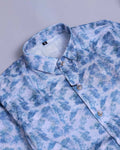 Blue and white patterned shirt on a light gray background