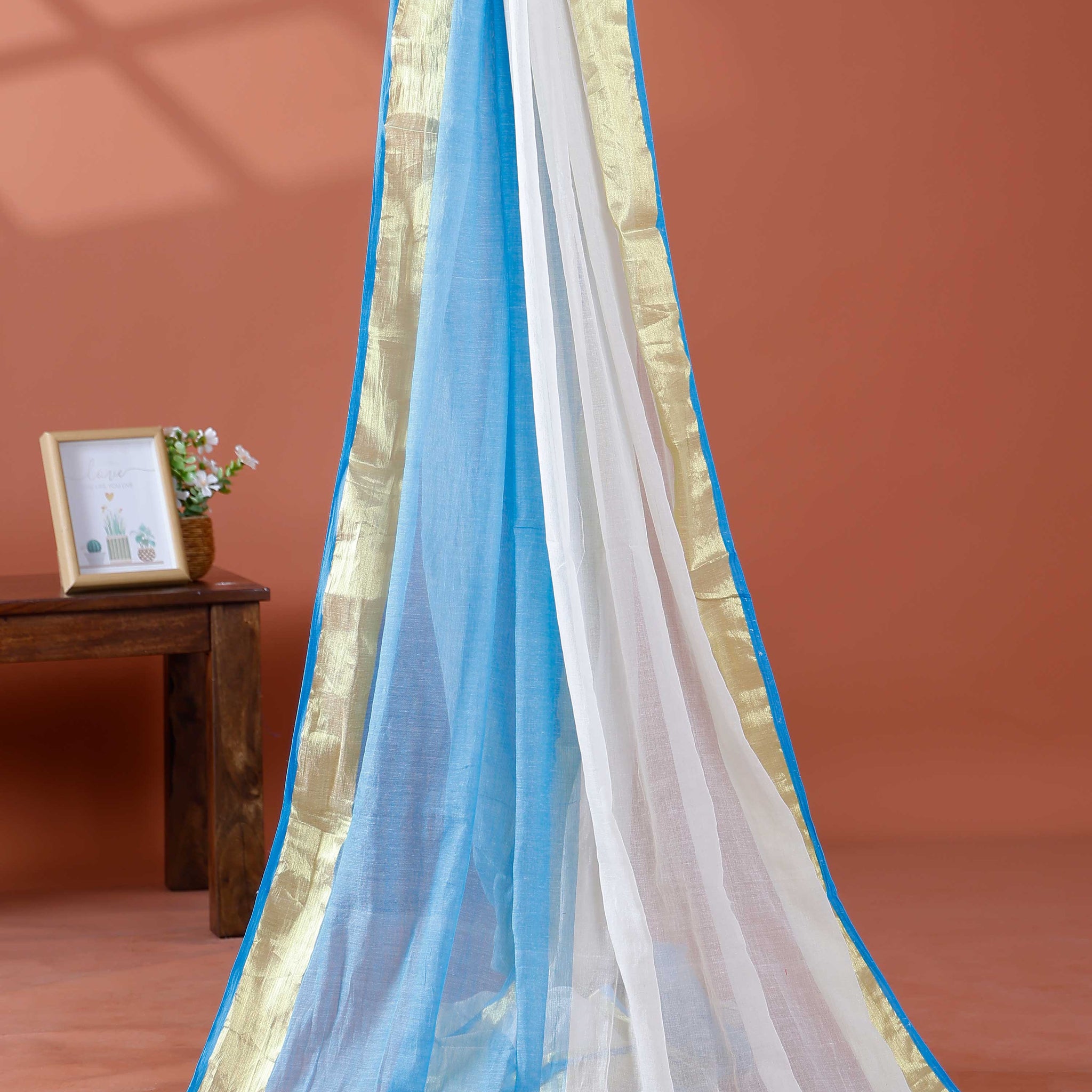 Handwoven Mul Mul Cotton Saree with Subtle Striped Pattern and Contrast Tassel Detailing – White