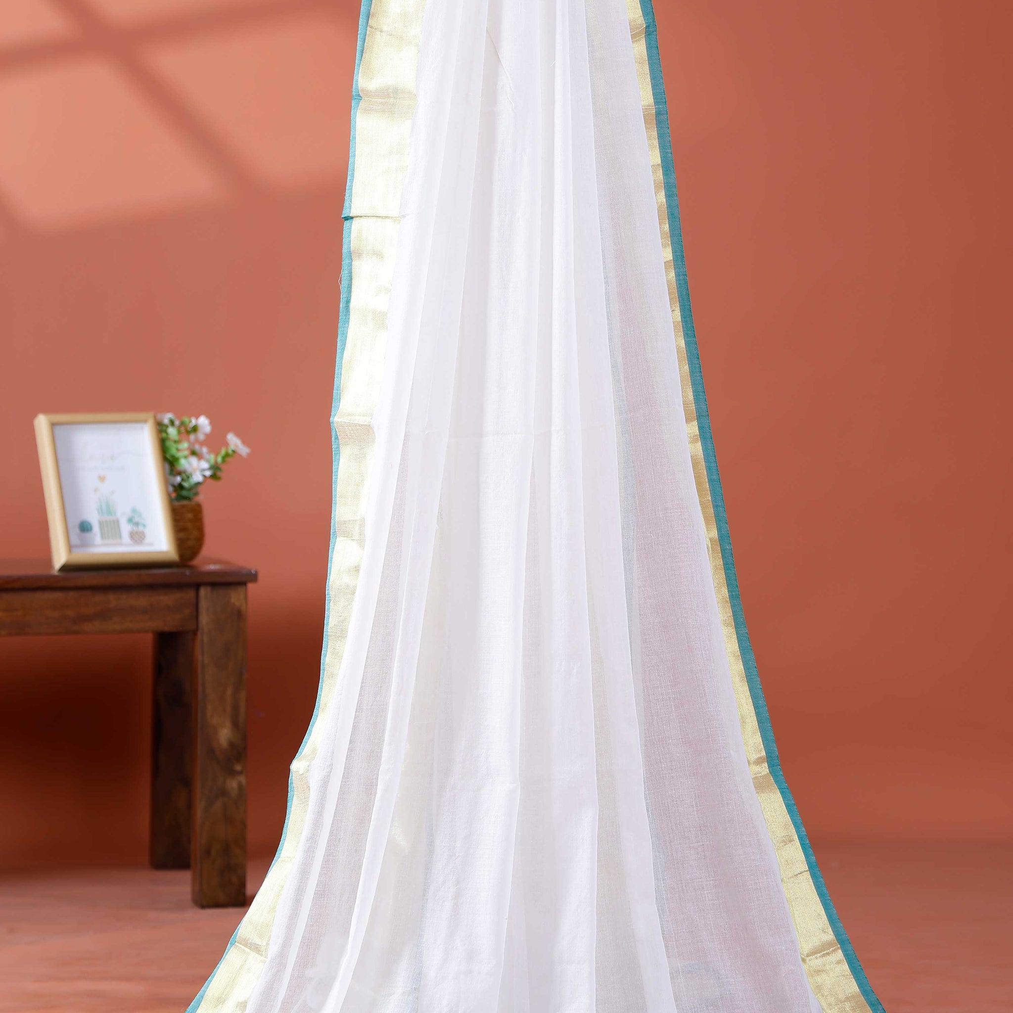Handwoven Mul Mul Cotton Saree with Subtle Striped Pattern and Contrast Tassel Detailing – White