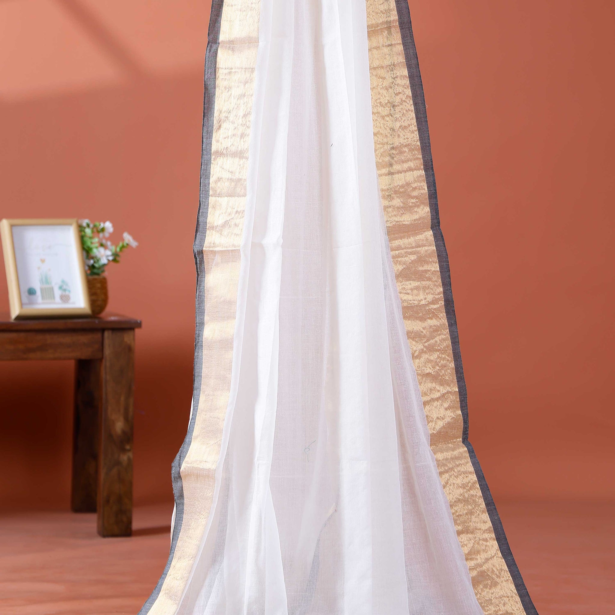 Handwoven Mul Mul Cotton Saree with Subtle Striped Pattern and Contrast Tassel Detailing – White