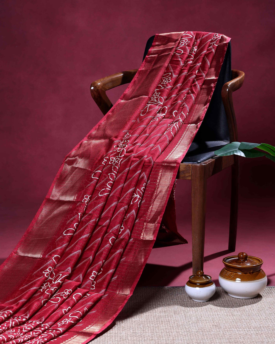 Elegant Dola Silk Saree with Chevron Weave Pattern Floral Motifs and Traditional Zari Border - Maroon