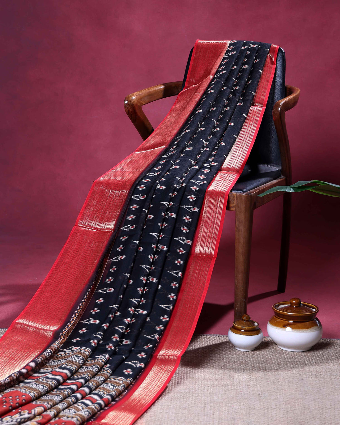 Elegant Dola Silk Saree with Intricate Ikkat Inspired Buta Motifs and Ornate Contrast Border - Black