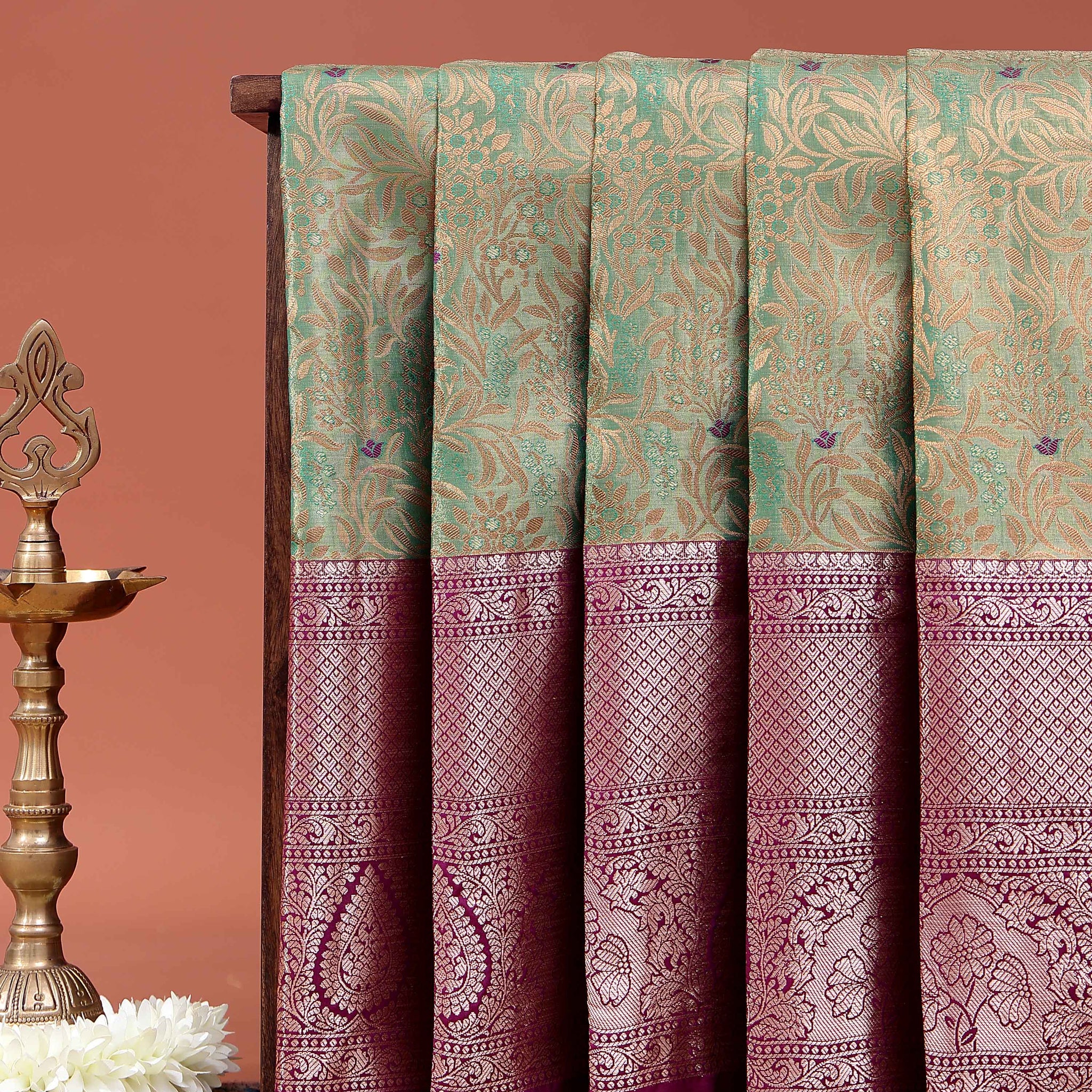 Elegant Niranjana Silk Saree Adorned with Detailed Zari Floral Patterns and Ornate Border - Green