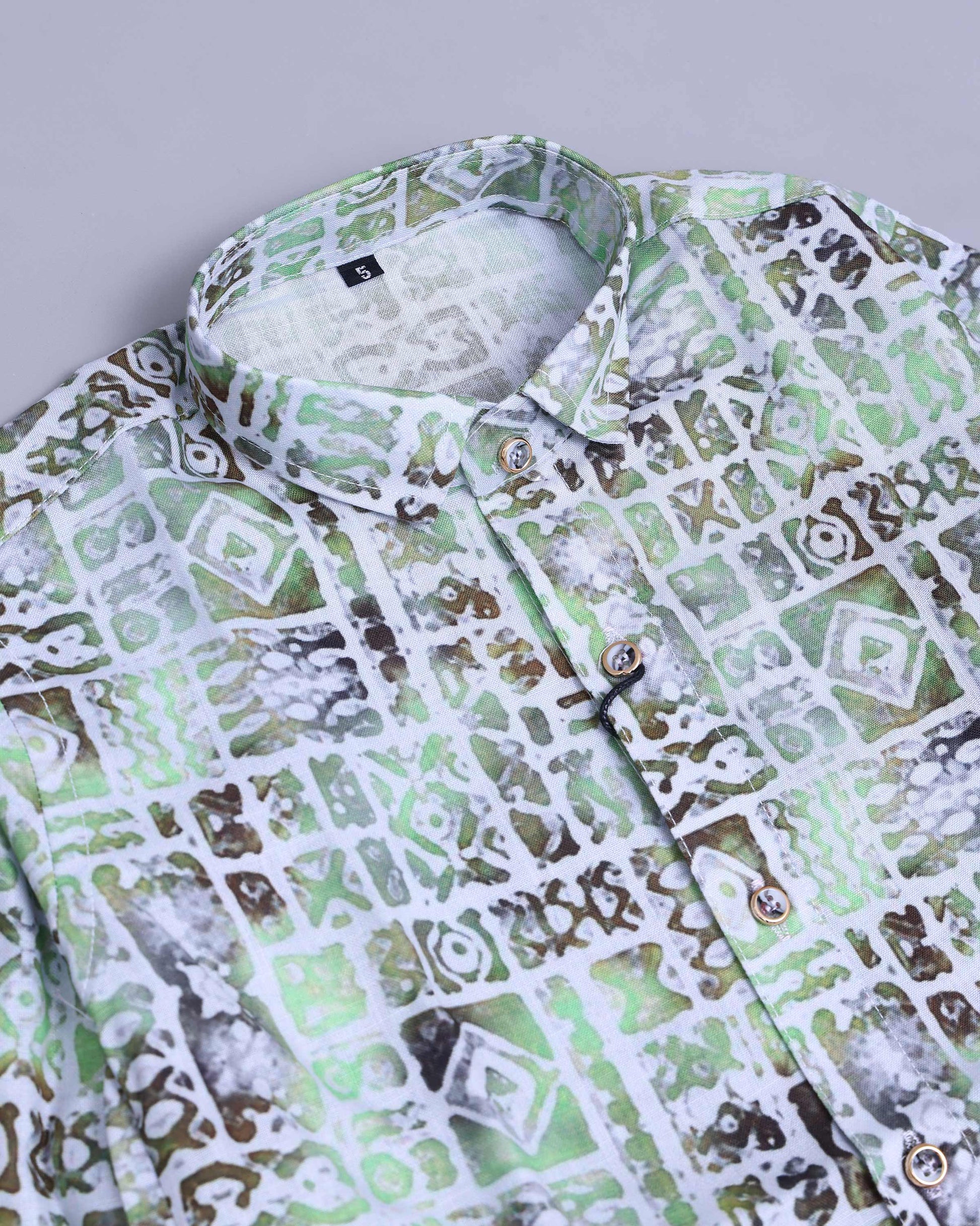Green and white patterned shirt on a light gray background