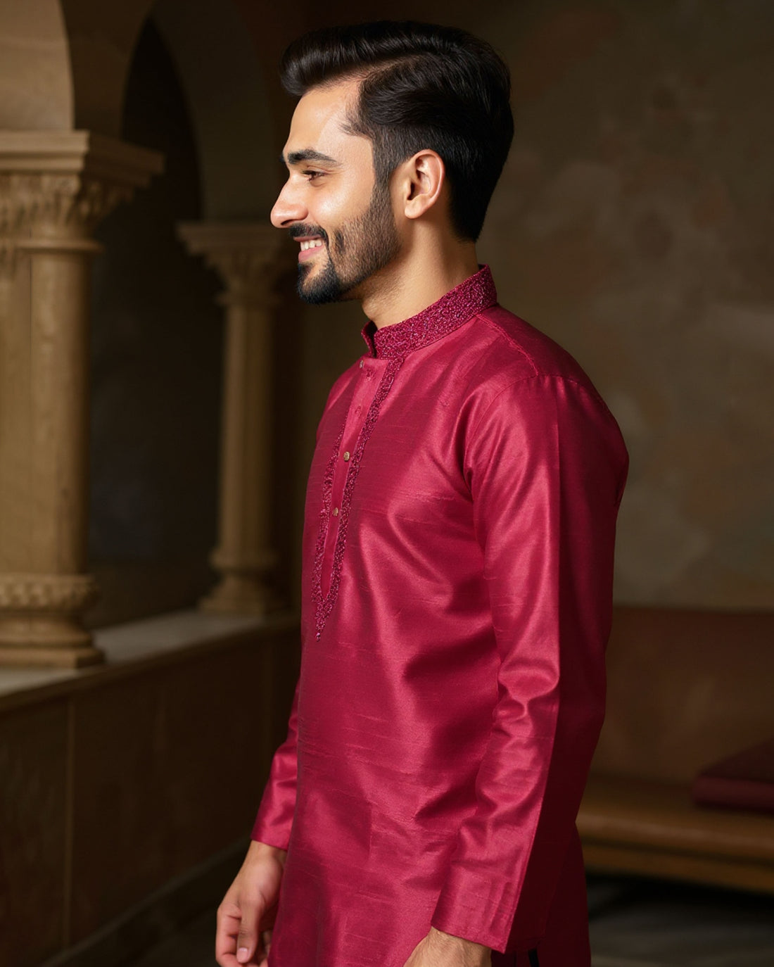 Man wearing a maroon kurta with white pants in an indoor setting