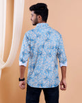 Man wearing a blue floral patterned shirt against a beige background
