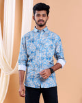 Man wearing a blue floral patterned shirt against a beige background