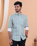 Man wearing a patterned shirt against a beige background