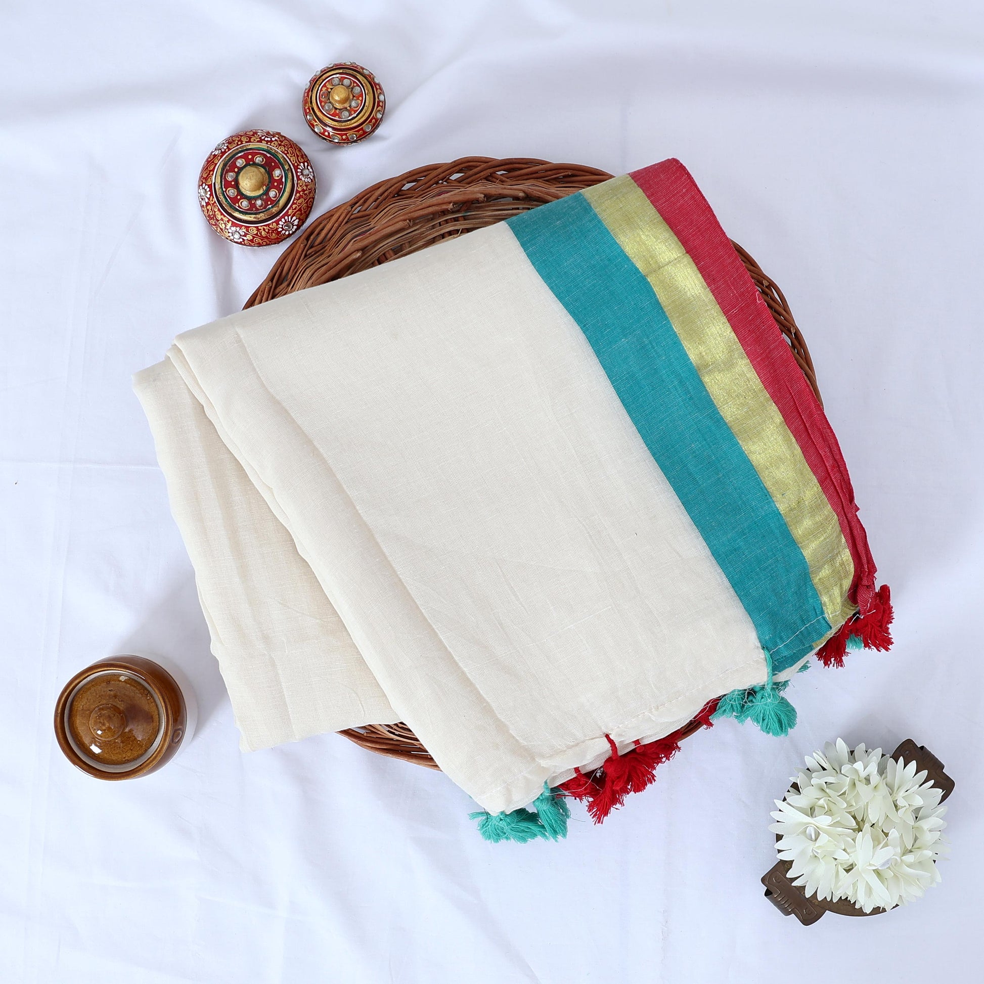 Mul mul cotton saree with cream body gold zari border teal and pink contrast stripes top view with tassels