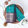 Elampillai silk cotton saree with silver zari floral motifs and broad contrast zari border in green top view