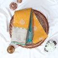 Light Yellow Elampillai silk cotton saree with silver zari floral buttas vertical stripes and contrast floral zari border folded top view
