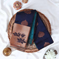 Elampillai silk cotton saree with floral zari border in navy blue folded top view on wicker basket display.