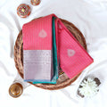 Pink Elampillai silk cotton saree with silver zari floral buttas vertical stripes and contrast floral zari border folded top view
