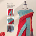 Red Elampillai silk cotton saree with gold zari buttas and contrast green zari border, front draped view on mannequin.