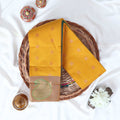 Yellow Elampillai silk cotton saree with gold zari buttas and contrast paisley zari border folded top view