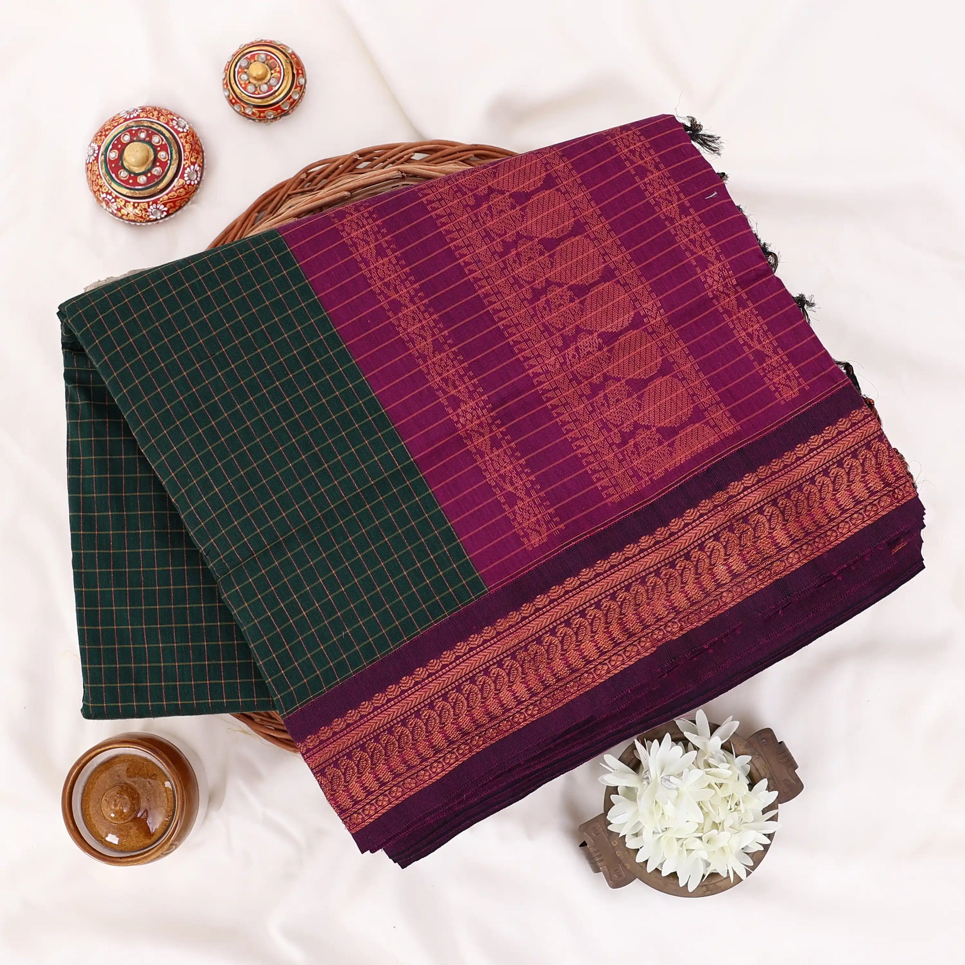 Kalyani Cotton saree with dark green  checked body and purple zari woven border, folded top view
