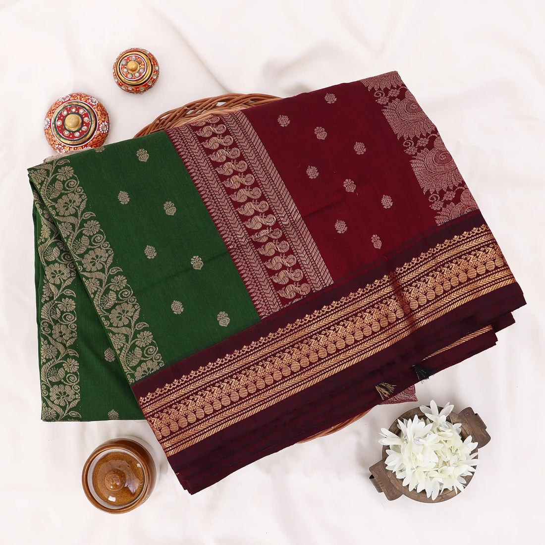 Kalyani Cotton saree with plain deep green body and maroon zari woven border, front drape view