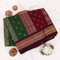 Kalyani Cotton saree with deep green body and maroon zari woven floral border, folded top view