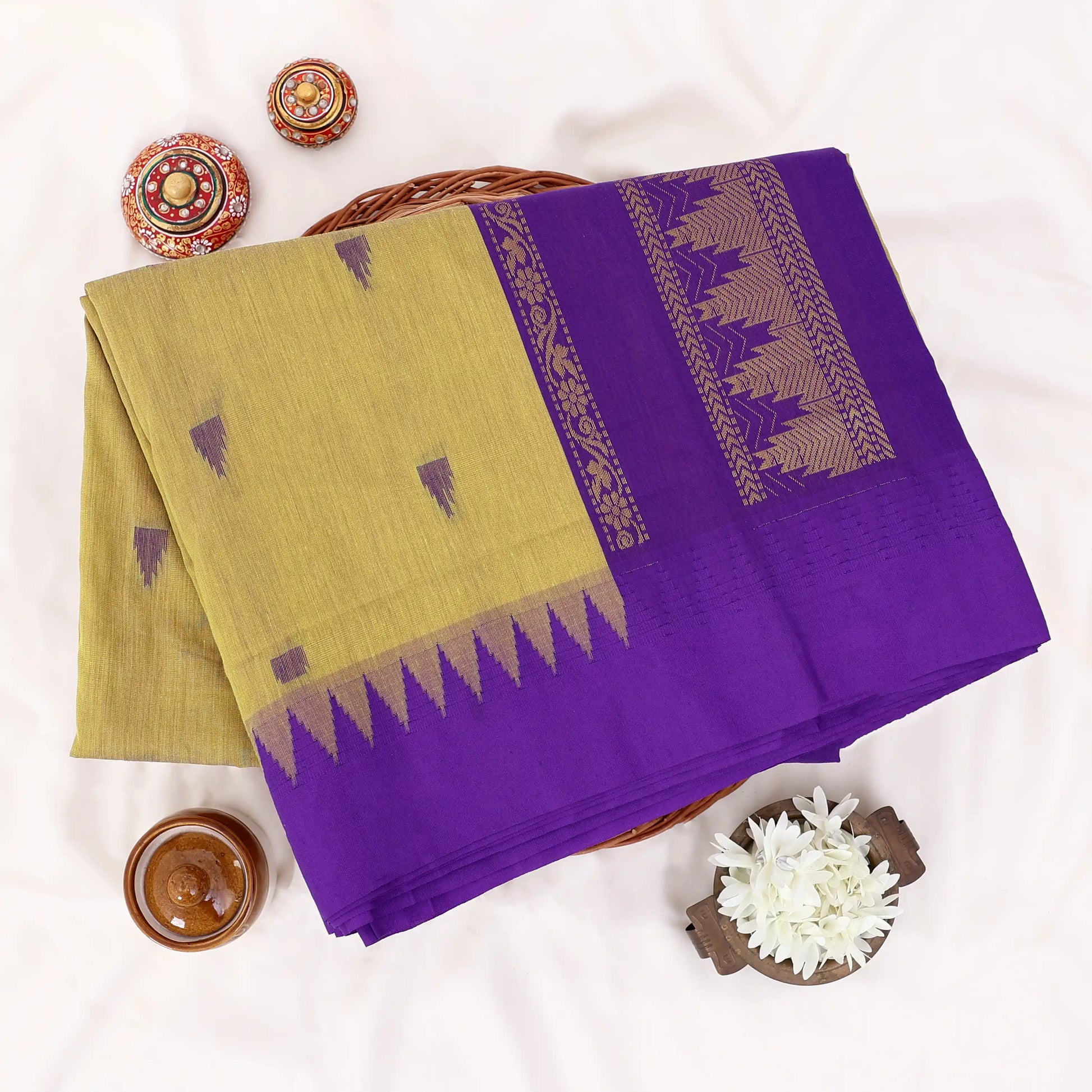 Kalyani Cotton saree with green body and violet zari border, folded top view