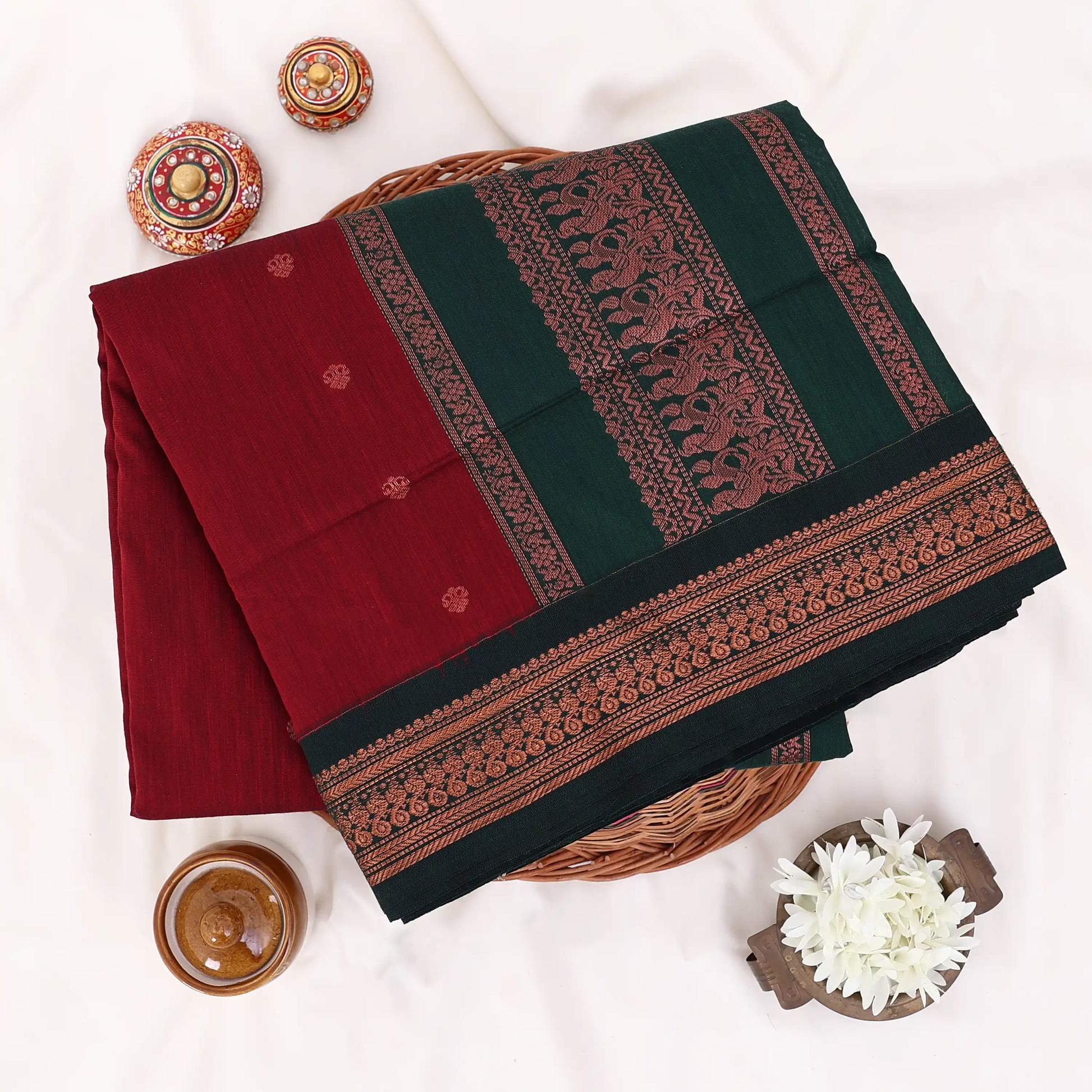 Kalyani Cotton saree with maroon body and dark green zari woven border,folded top view