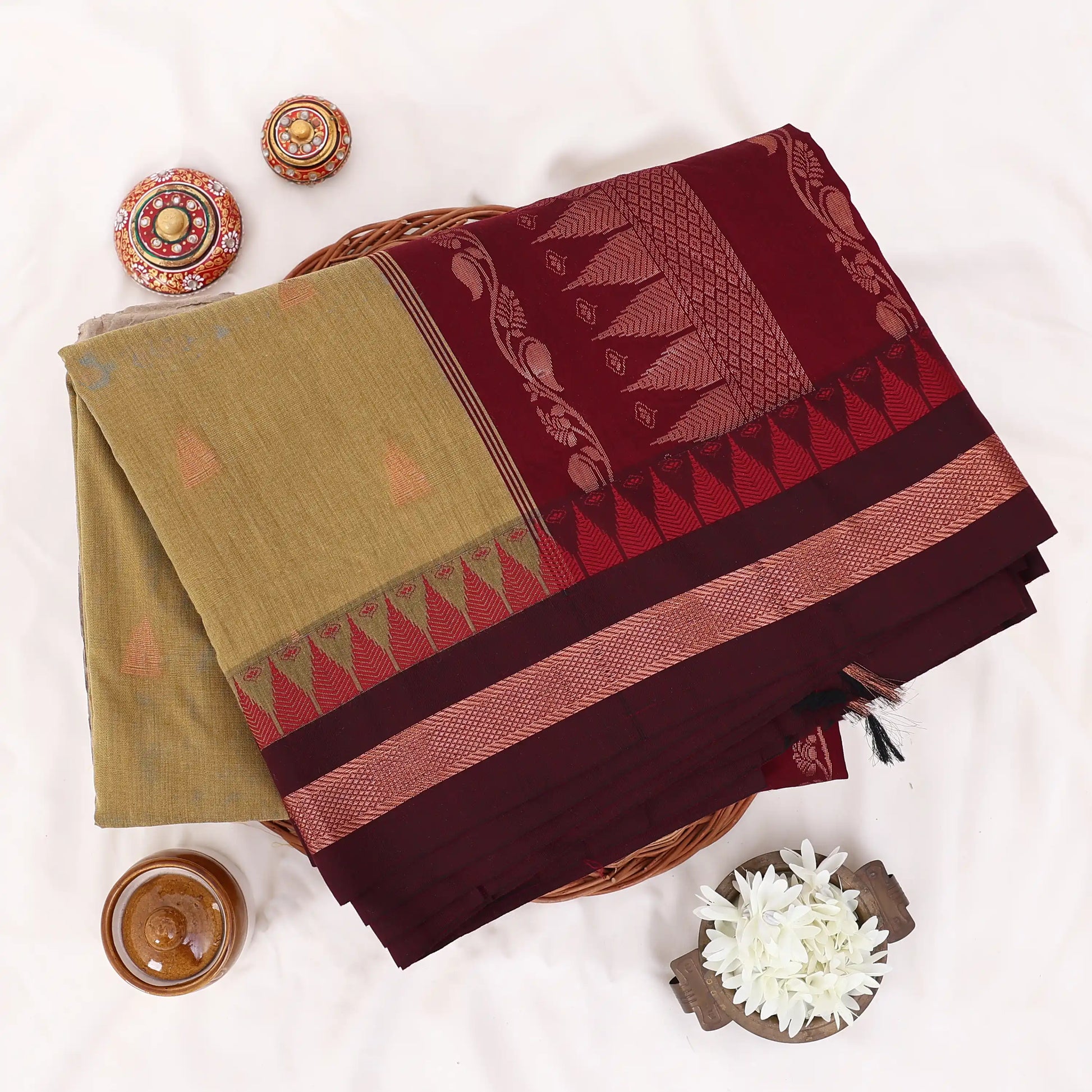 Kalyani Cotton saree with Olive green body and maroon zari border, folded top view