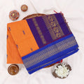 Kalyani Cotton saree with deep orange body and blue zari woven border, folded top view
