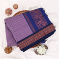 Kalyani Cotton saree with lavender  checked body and blue zari woven border, folded top view