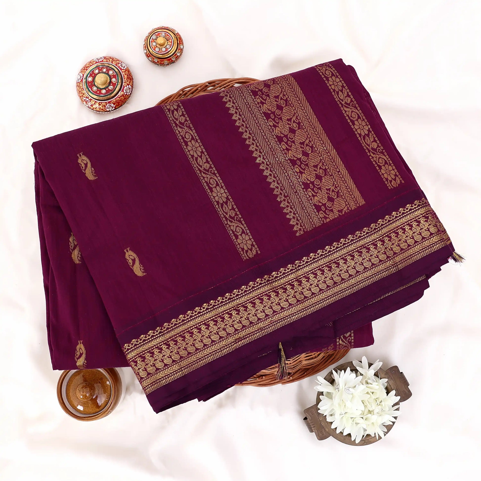 Kalyani Cotton saree with deep purple body and golden zari woven border, folded top view