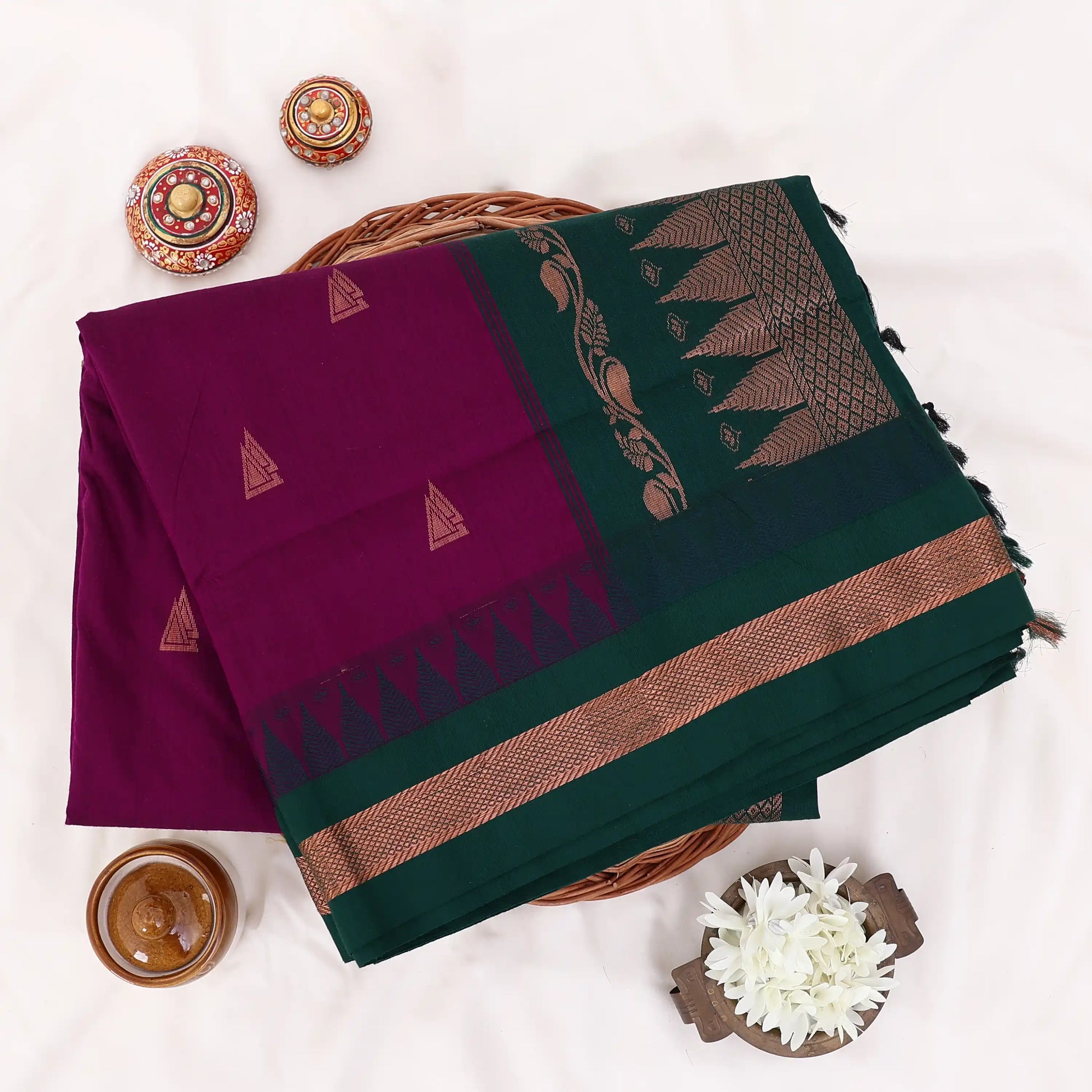 Kalyani Cotton saree with purple body and green zari border, folded top view
