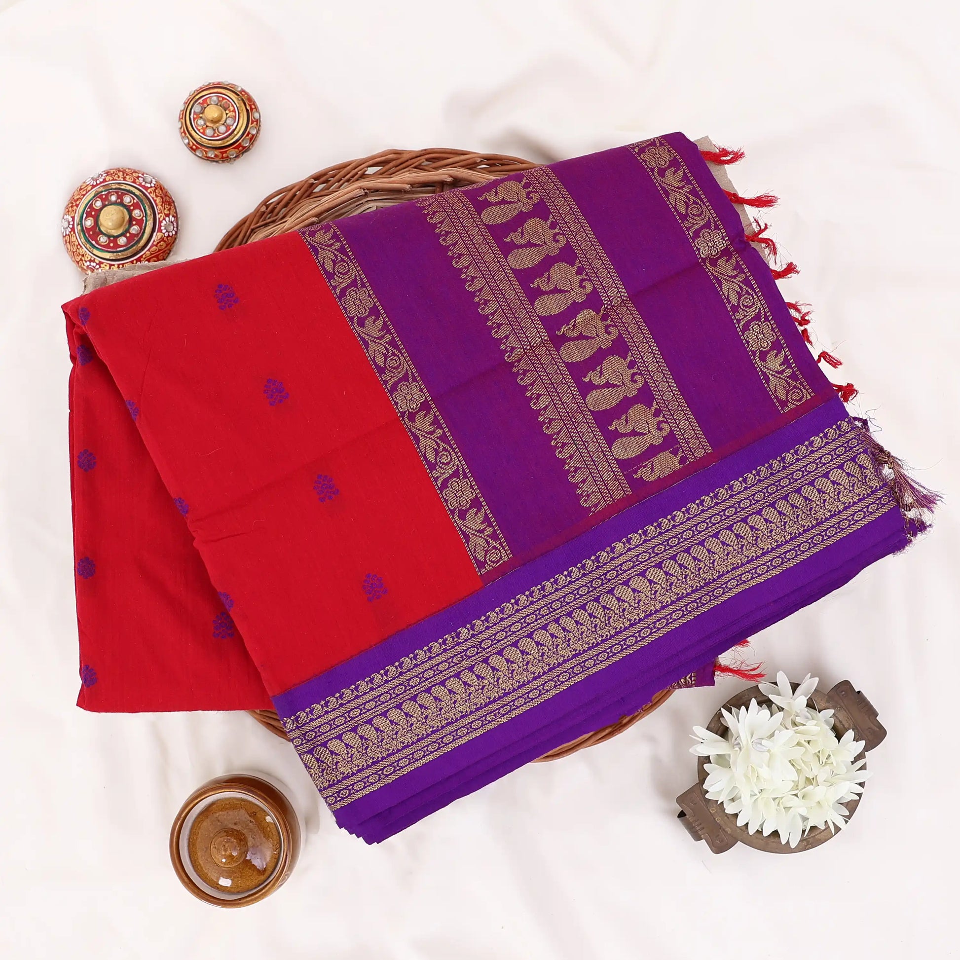 Kalyani Cotton saree with Red body and violet zari woven floral border,Folded top view